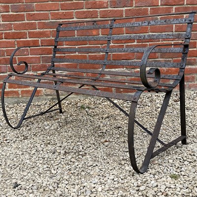 Lot 1445 - An old black-painted wrought iron garden bench