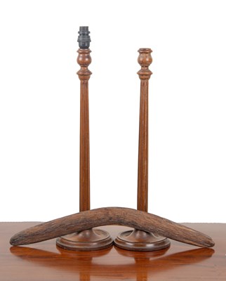 Lot 1271 - A pair of turned walnut table lamps and a boomerang