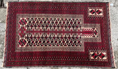 Lot 57A - Rectangular form rug Baluchi, burgundy ground...
