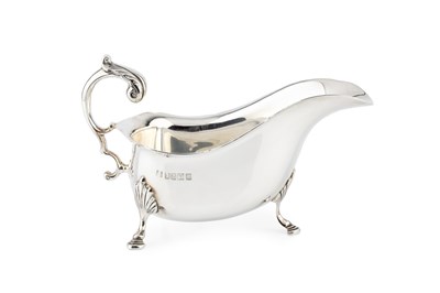 Lot 740 - An Irish silver sauce boat, with shaped border...