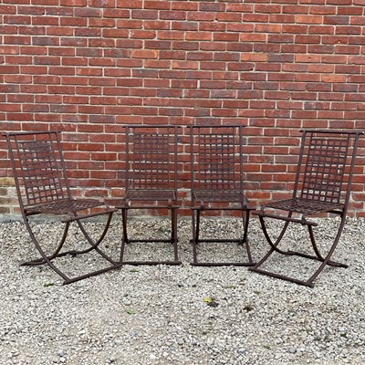 Lot 1417 - A set of four wrought iron folding garden chairs