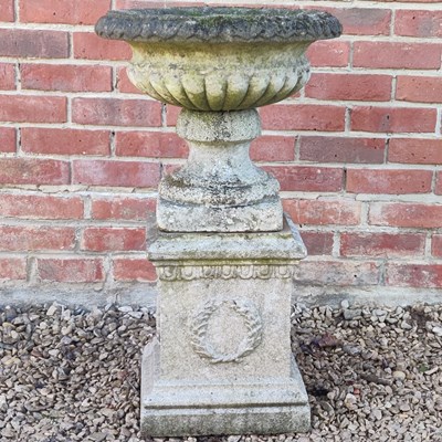 Lot 1467 - A cast composite urn on a plinth