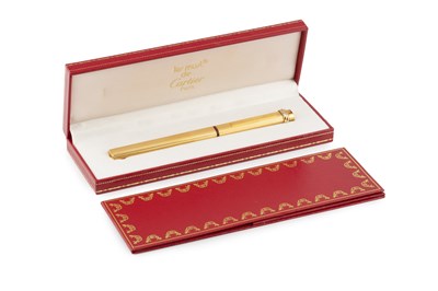 Lot 538 - A gold plated roller-ball pen by Cartier, of...
