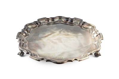 Lot 796 - A silver salver, with shaped border, on scroll...