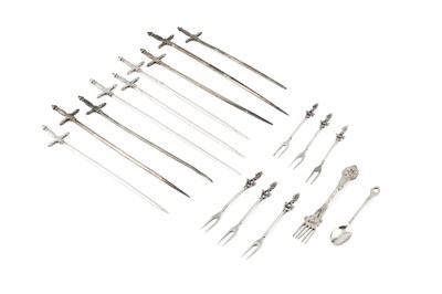 Lot 812 - A collection of nine Egyptian silver skewers,...
