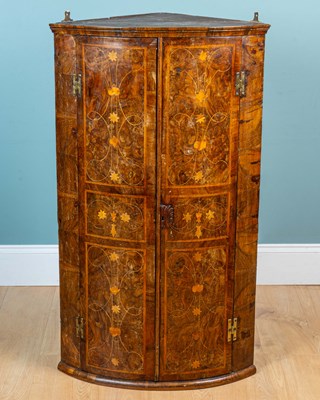 Lot 443 - An 18th century bow-fronted wall hanging corner cabinet