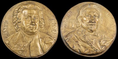 Lot 76 - Two circular embossed wall plaques of composers