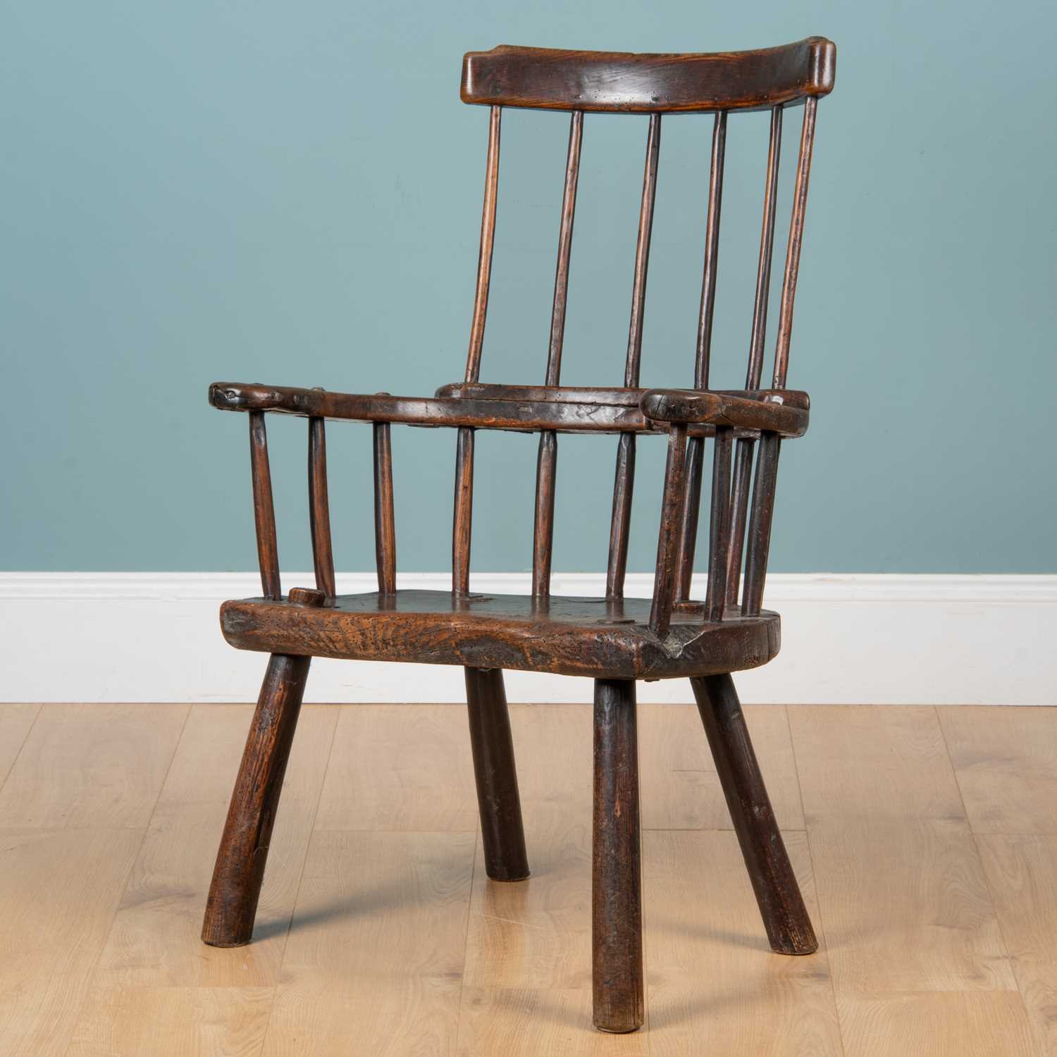 Lot 59 - A late 18th/early 19th century primitive elm Windsor chair