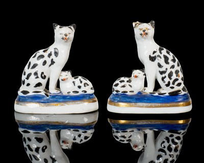 Lot 46 - A pair of Staffordshire-style hard-paste porcelain flat-back cats