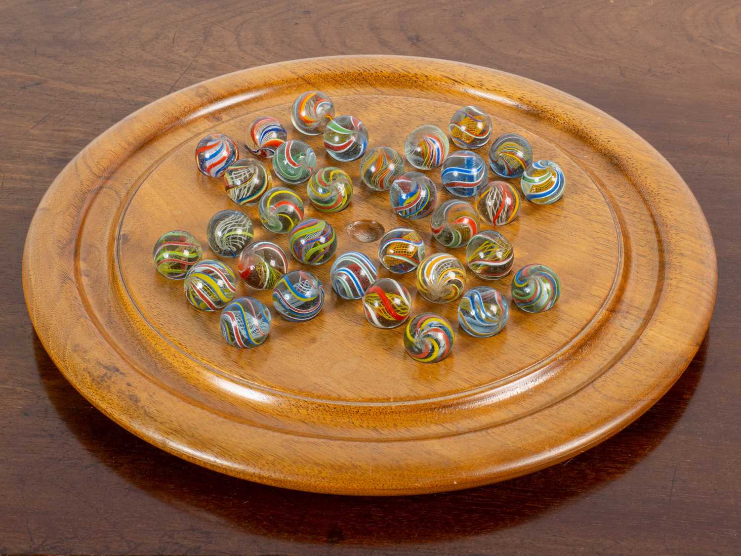 Lot 1306 - A walnut solitaire board and a set of possibly 19th century marbles