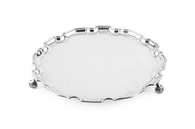 Lot 856 - A silver salver, with shaped border, on scroll...