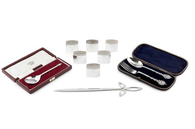 Lot 859 - A set of six silver napkin rings, of bowed...