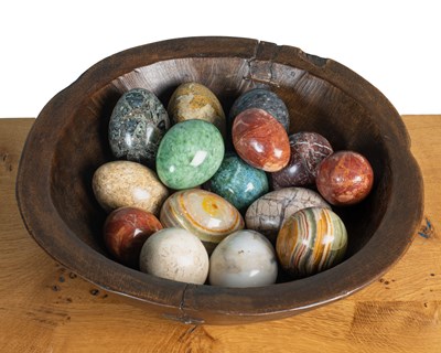 Lot 229 - A rustic wooden bowl together with a collection of hardstone eggs