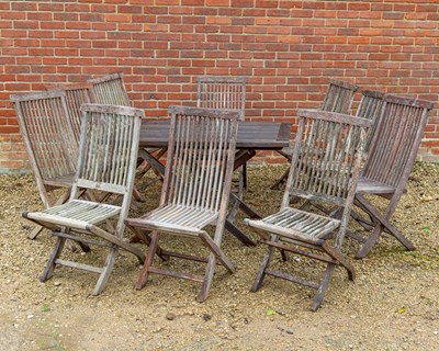 Lot 1073 - A teak folding garden table together with ten chairs
