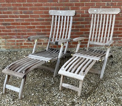 Lot 1097 - A pair of teak steamer chairs