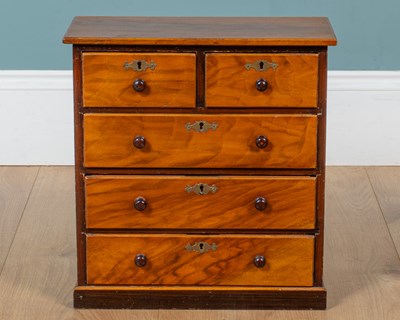 Lot 444 - An antique walnut veneered table top chest of drawers