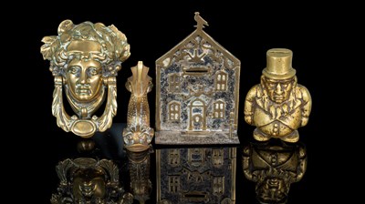 Lot 86 - Two money boxes and two door knockers