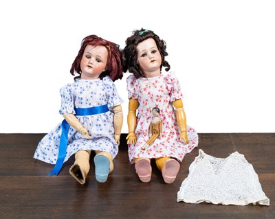 Lot 1309 - Two Heubach bisque-headed dolls, together with a small peg doll