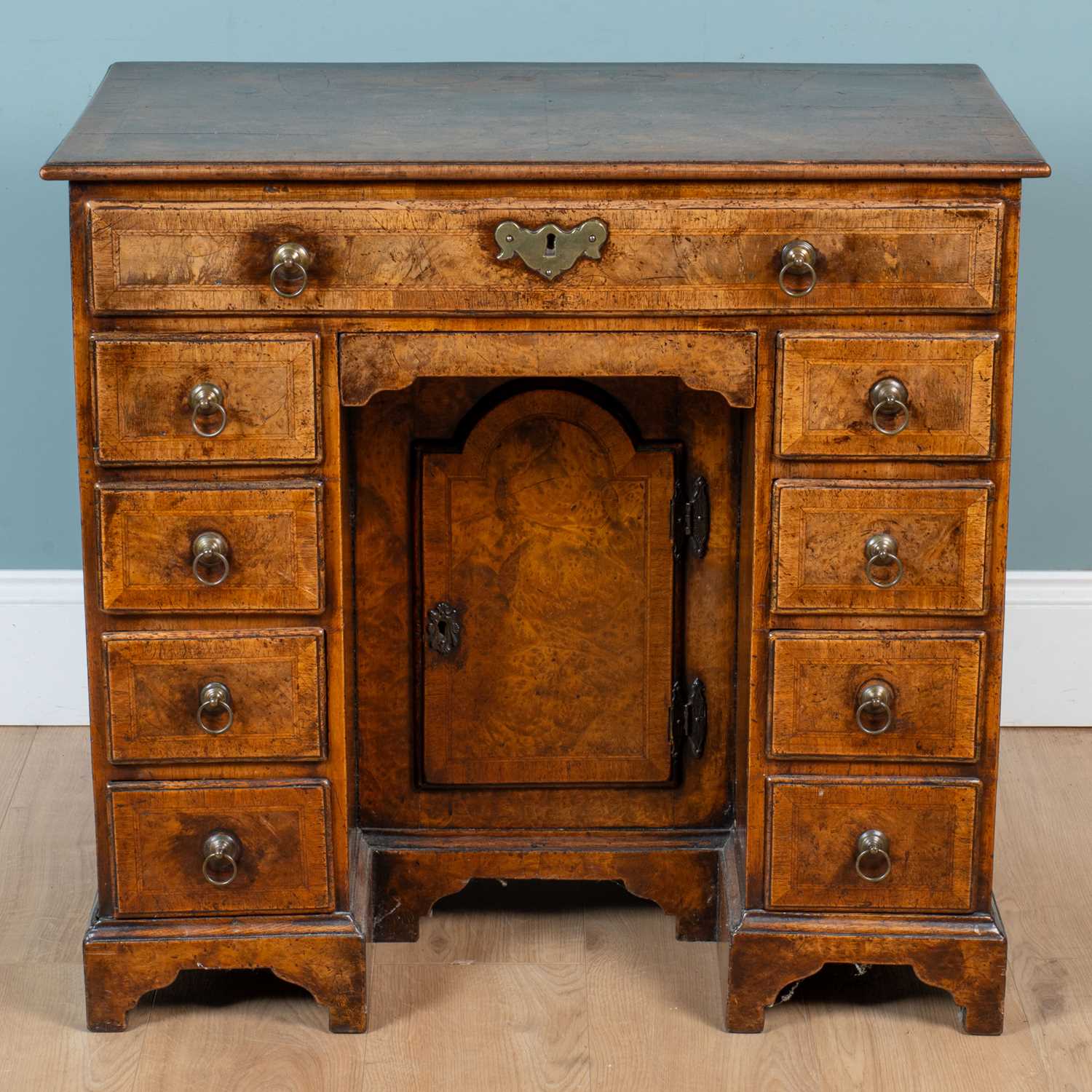 Lot 10 - A Queen Anne style walnut kneehole desk