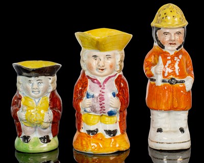 Lot 251 - Two early 19th century Staffordshire small toby jugs together with a 19th century Staffordshire caster
