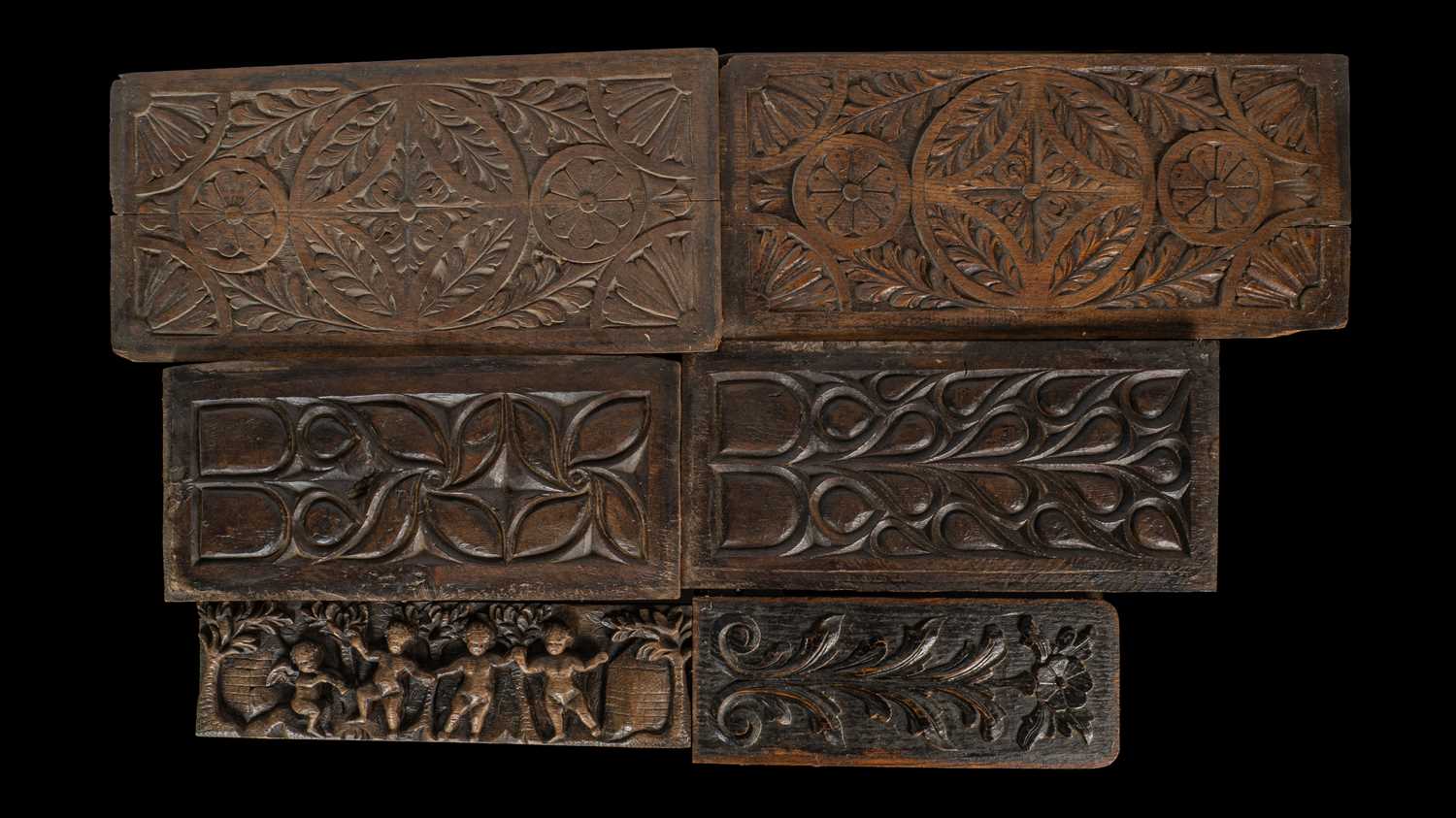 Lot 35 - An antique carved panel depicting dancing putti together with five further carved panels