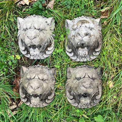 Lot 1034 - A group of four cast reconstituted stone lion mask fountain spouts