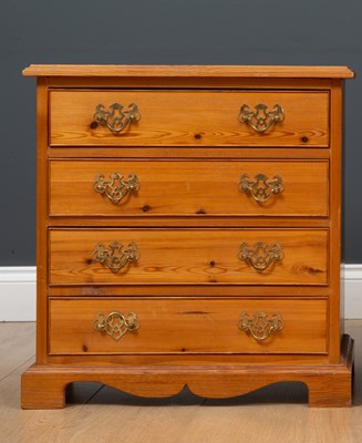 Lot 474 - A pair of pine bedside tables of four drawers...