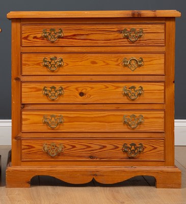 Lot 475 - A pair of pine bedside tables of four drawers...