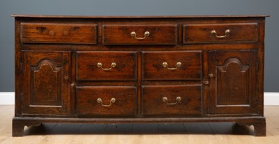 Lot 476 - A 19th century oak dresser base of three long...