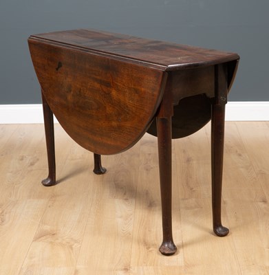 Lot 479 - An oak drop leaf table on four paw feet, 104cm...