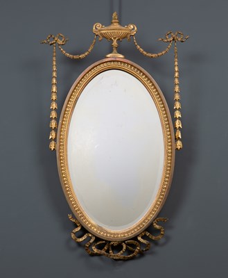 Lot 175 - An antique gilt oval wall mirror  with urn...