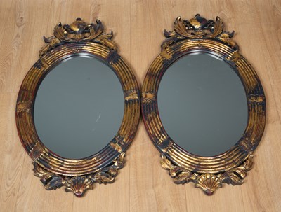 Lot 504 - A pair of parcel gilt oval wall mirrors with...