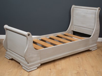Lot 512 - A grey painted French style day bed with...