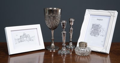 Lot 39 - A pair of silver candlesticks with raised...