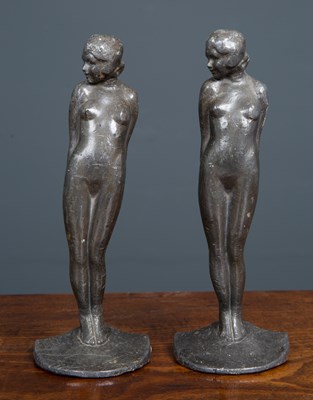 Lot 523 - A pair of lead bookends formed as nude women,...