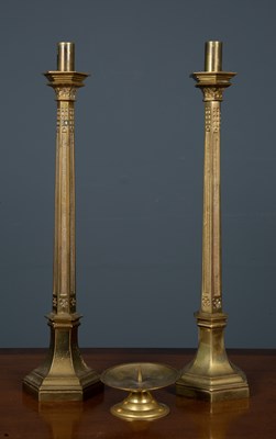 Lot 435 - A pair of brass candlesticks formed as fluted...