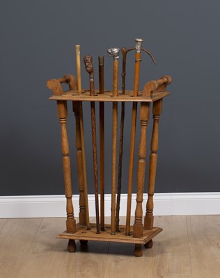 Lot 176 - An oak stick stand for displaying walking...