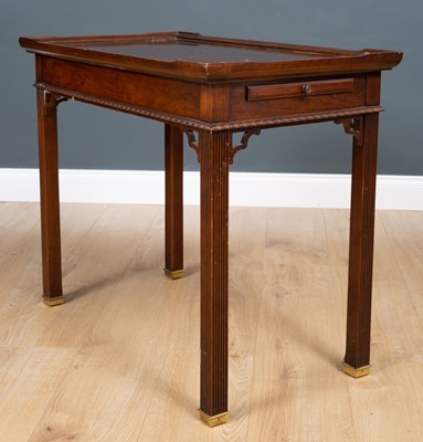 Lot 625 - A mahogany tea table with pull out slides on...