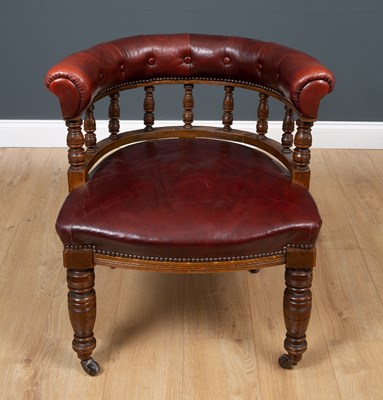 Lot 633 - An antique oak and red leather desk chair with...