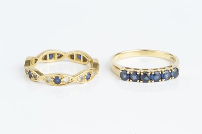 Lot 132 - A sapphire half hoop ring, the line of...