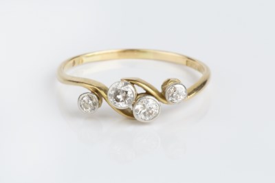 Lot 157 - A diamond four stone dress ring, of crossover...