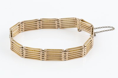 Lot 5 - A yellow precious metal gate-link bracelet,...