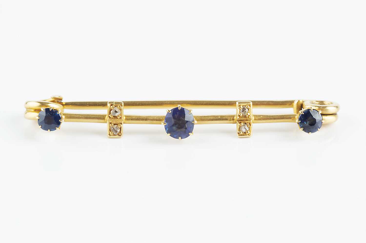 Lot 140 - A sapphire and diamond set bar brooch, the...