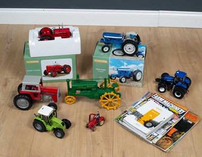 Lot 101 - A collection of model tractors comprising of a...