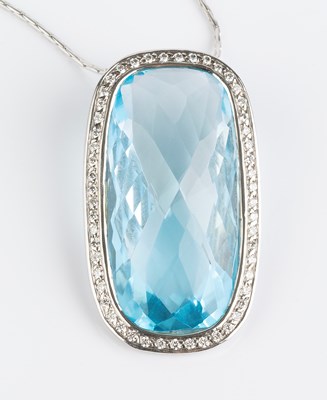 Lot 176 - A blue topaz and diamond cluster pendant on...