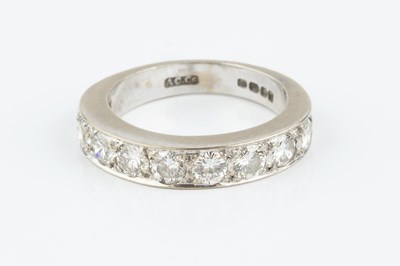 Lot 148 - A diamond half hoop ring, the line of uniform...