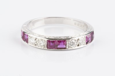 Lot 138 - A ruby and diamond half hoop ring, alternately...