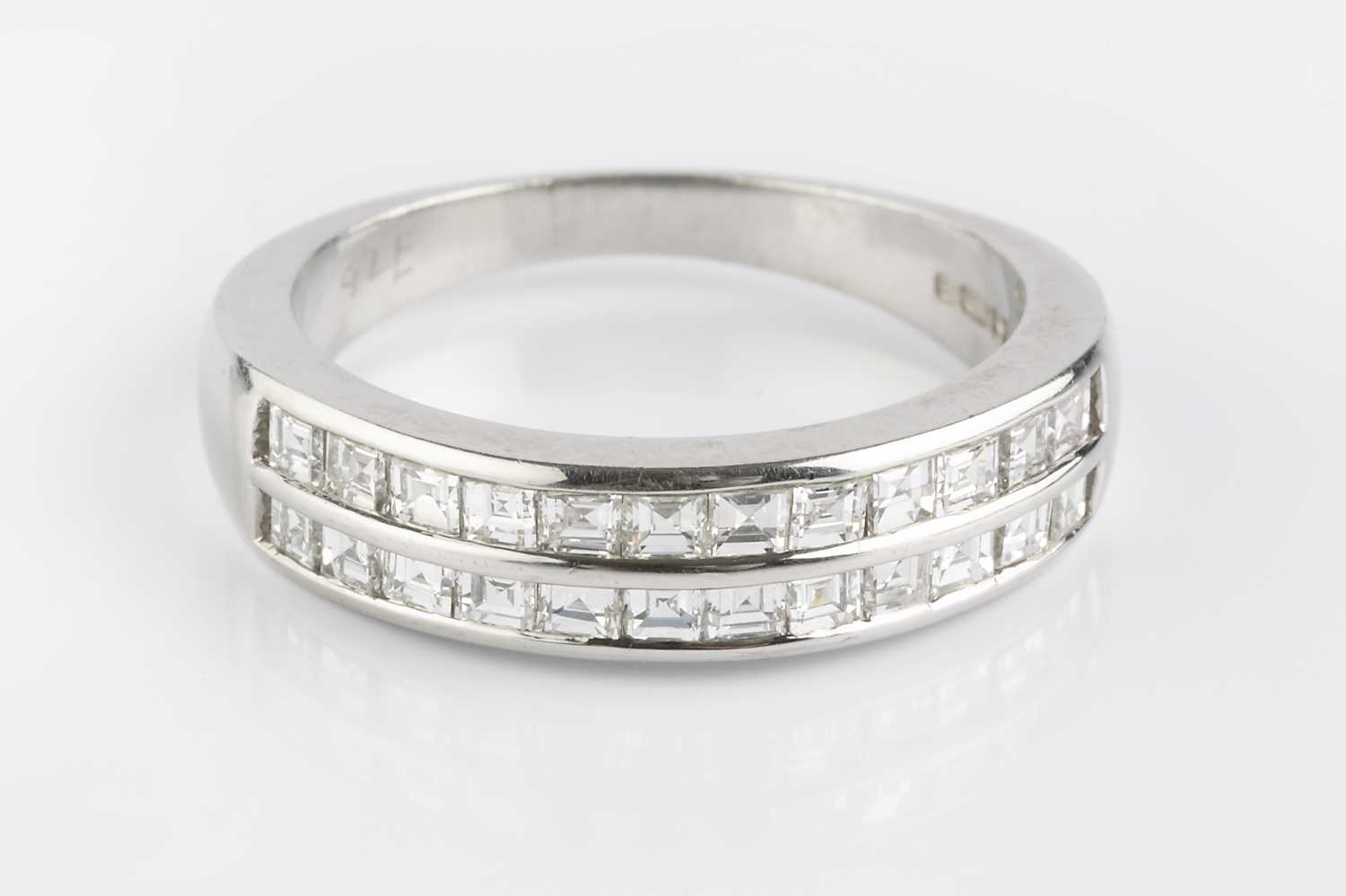 Lot 74 - A diamond double row half hoop ring, channel...