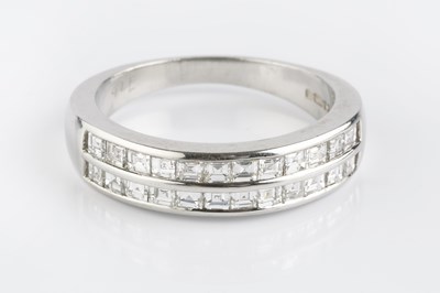 Lot 74 - A diamond double row half hoop ring, channel...