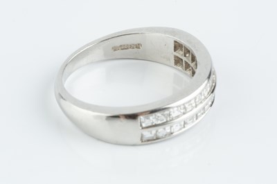 Lot 74 - A diamond double row half hoop ring, channel...